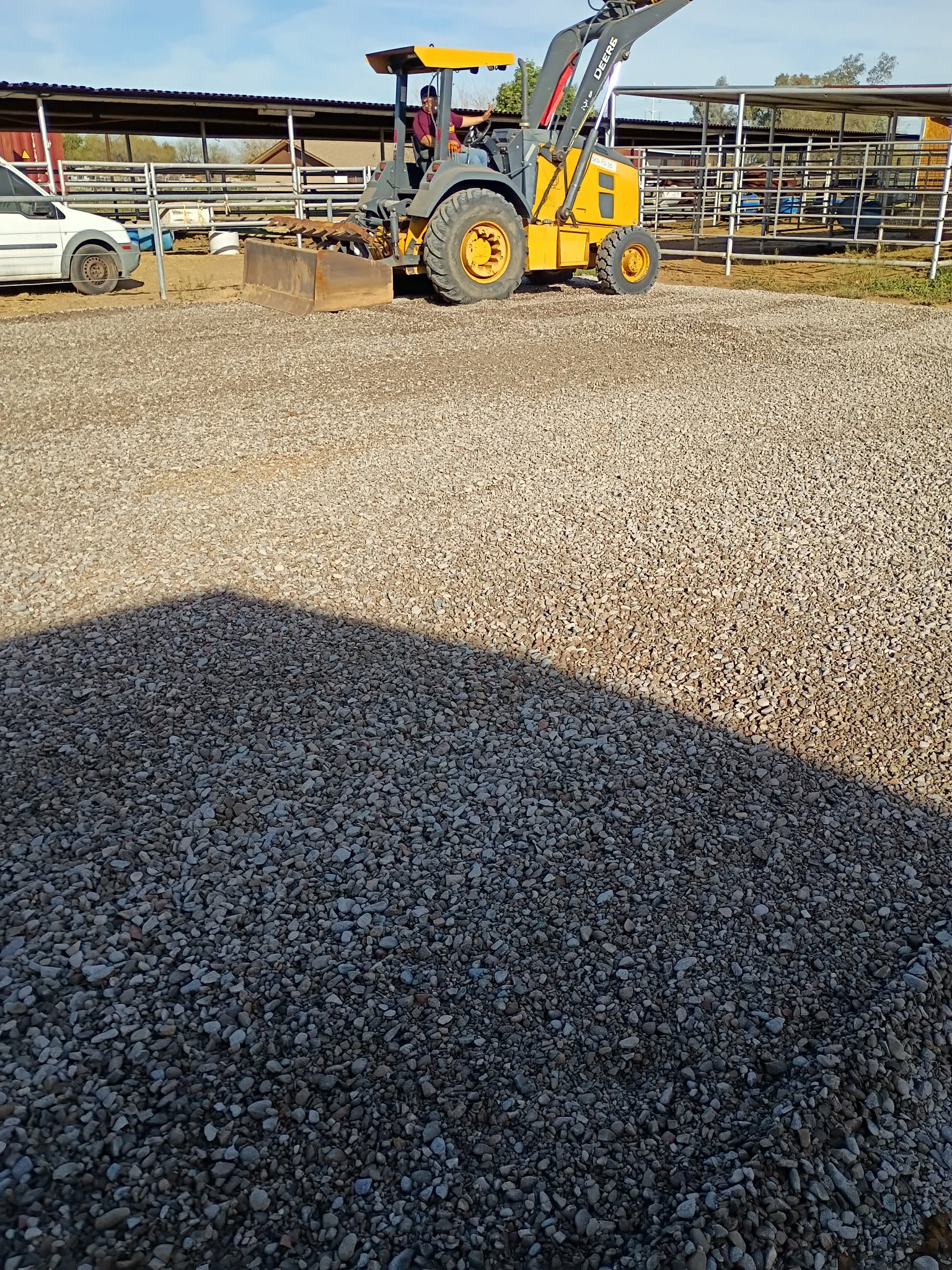 Skid steer spreading gravel